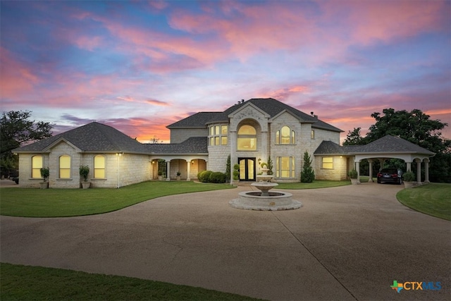 french country inspired facade featuring a carport and a lawn