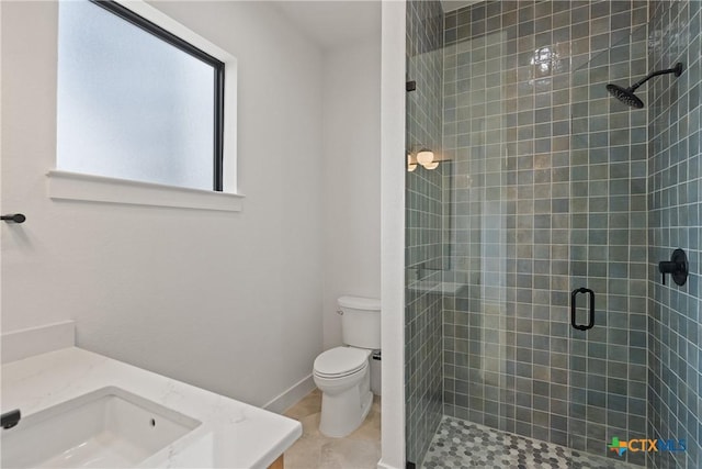 full bath featuring toilet, vanity, tile patterned floors, and a stall shower
