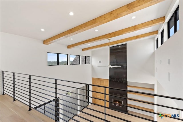 staircase with a ceiling fan, wood finished floors, beam ceiling, and recessed lighting