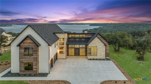 view of front of home with a standing seam roof and stone siding