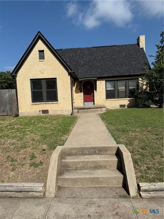 1500 N 5th St, Temple, TX 76501 - view of front of home featuring brick siding, a chimney, and roof with shingles