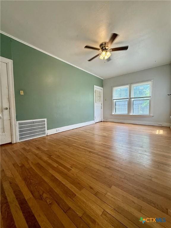 1500 N 5th St, Temple, TX 76501 - unfurnished room featuring wood-type flooring, ceiling fan, ornamental molding, and baseboards