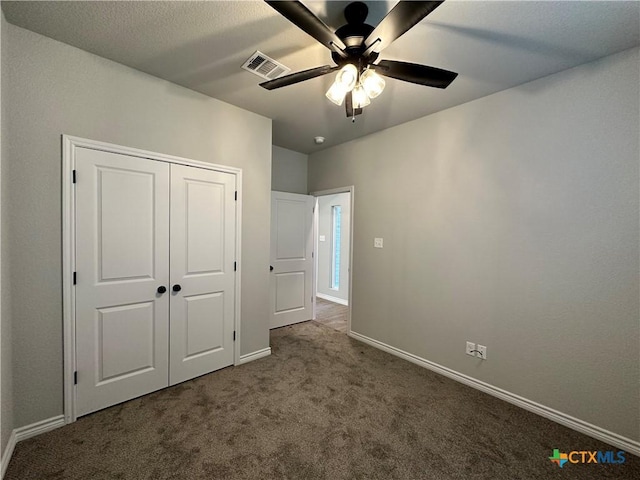 unfurnished bedroom featuring carpet flooring, ceiling fan, and a closet