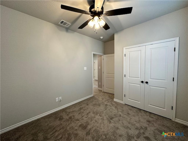 unfurnished bedroom featuring ceiling fan, carpet floors, and a closet