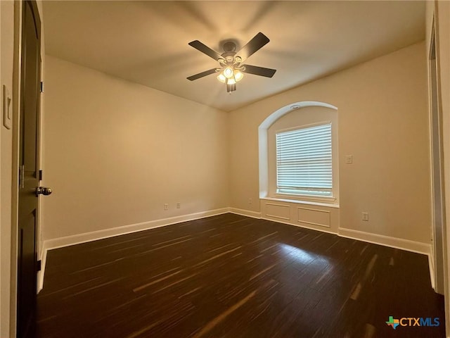 empty room featuring ceiling fan and dark wood-type flooring