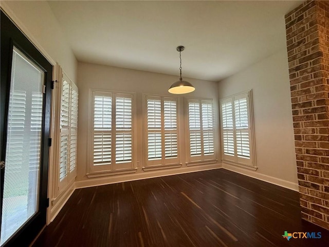 unfurnished dining area with dark hardwood / wood-style flooring