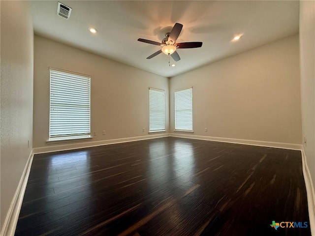 empty room featuring ceiling fan and dark hardwood / wood-style floors