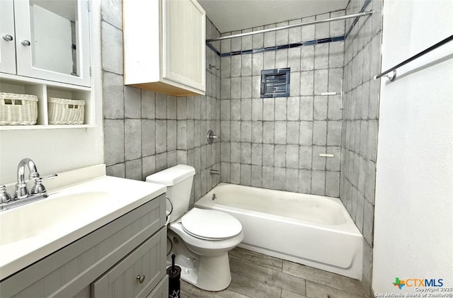 full bathroom with tiled shower / bath, vanity, toilet, and wood-type flooring