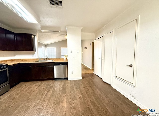 kitchen featuring butcher block counters, sink, light wood-type flooring, stainless steel dishwasher, and stove