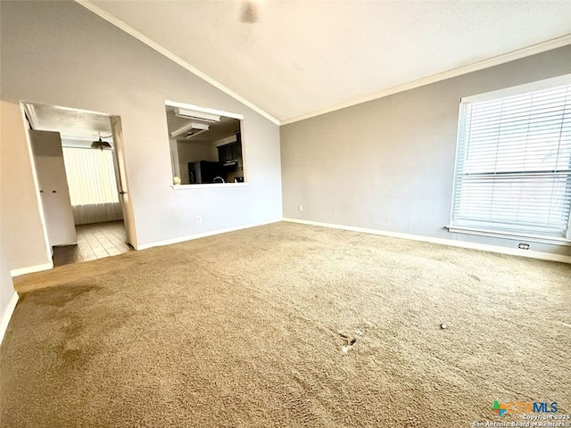 unfurnished living room featuring crown molding, vaulted ceiling, a textured ceiling, and carpet