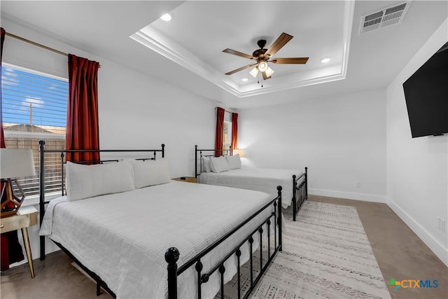 bedroom featuring ceiling fan and a raised ceiling