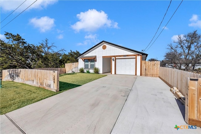 ranch-style home with a garage and a front yard