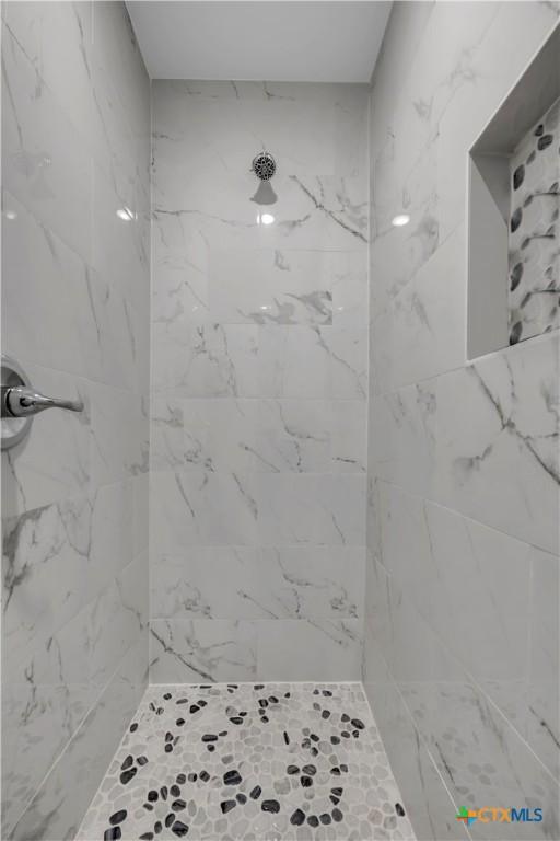 bathroom with tiled shower