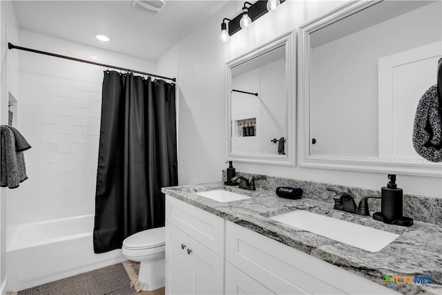 full bathroom with shower / tub combo, vanity, and toilet