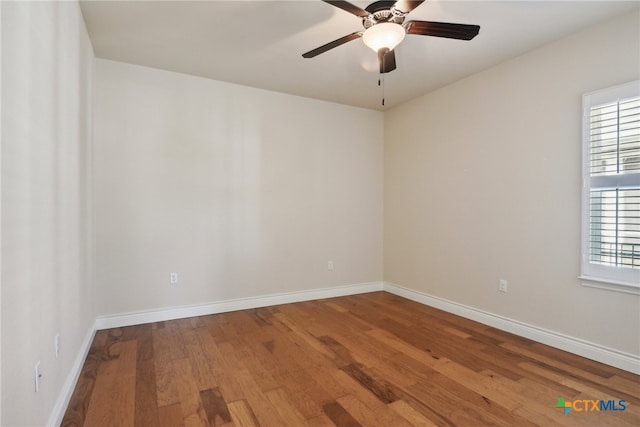 empty room featuring hardwood / wood-style flooring and ceiling fan