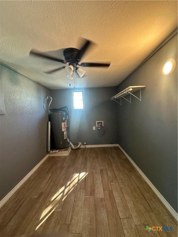 laundry room with hardwood / wood-style flooring, electric water heater, a textured ceiling, and washer hookup