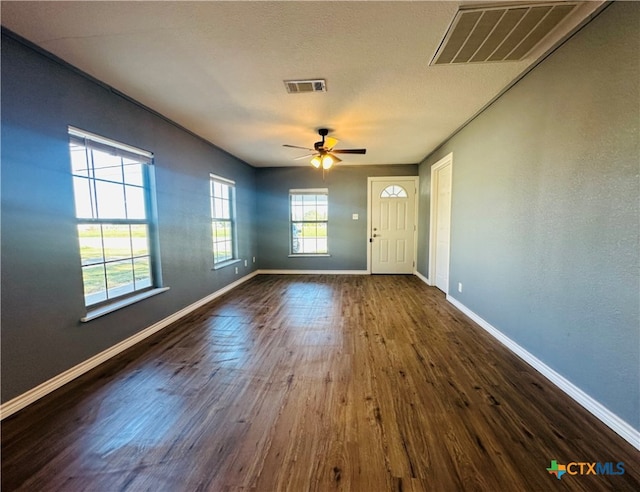 interior space featuring ceiling fan and dark wood-type flooring