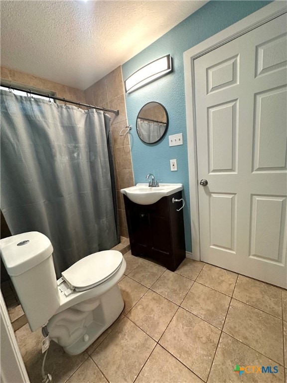 bathroom featuring tile patterned floors, vanity, a shower with curtain, and a textured ceiling