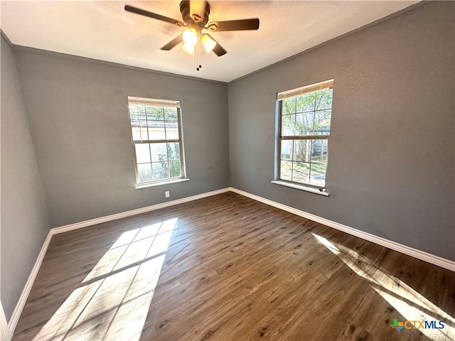 empty room featuring hardwood / wood-style flooring, ceiling fan, and ornamental molding