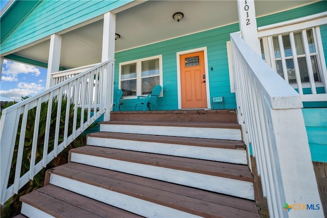 view of exterior entry with a porch