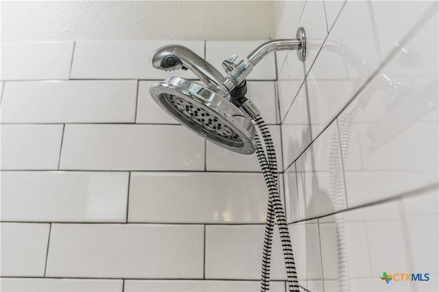 interior details featuring tiled shower