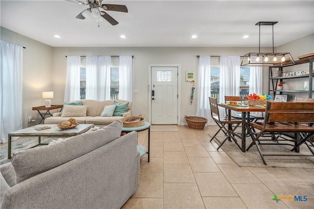 living area with light tile patterned floors, ceiling fan, and recessed lighting