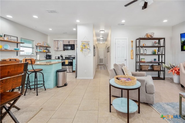 living room with light tile patterned floors, recessed lighting, and visible vents