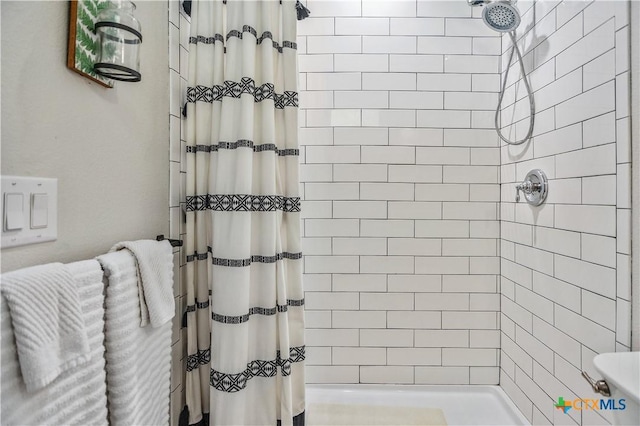 bathroom with a shower stall