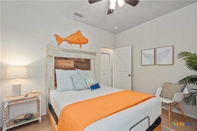 tiled bedroom with visible vents, baseboards, and a ceiling fan