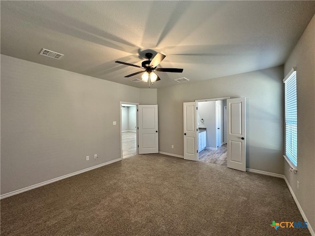 unfurnished bedroom featuring ceiling fan and carpet