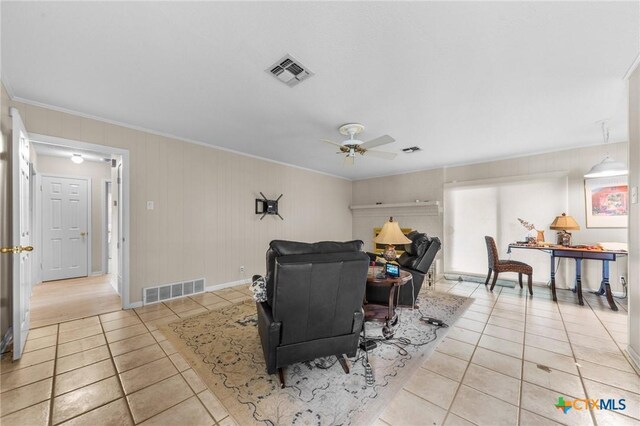 living area featuring visible vents, ornamental molding, ceiling fan, and light tile patterned floors