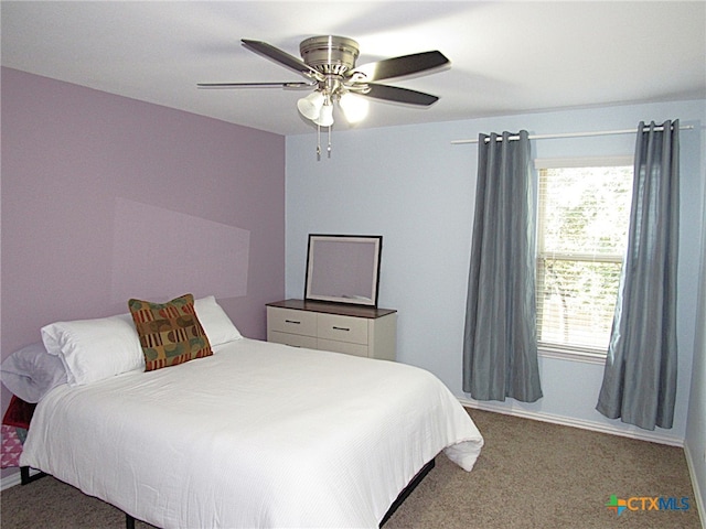 bedroom with dark colored carpet and ceiling fan