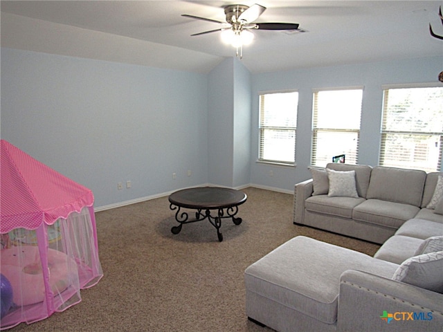 living room featuring ceiling fan, carpet flooring, and lofted ceiling