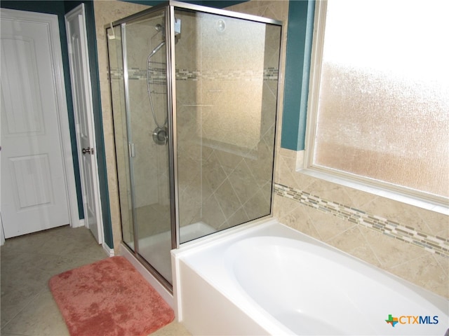 bathroom featuring tile patterned floors and plus walk in shower