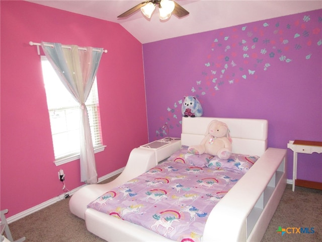 carpeted bedroom with ceiling fan and vaulted ceiling