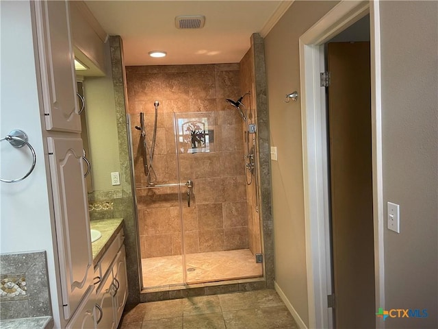 bathroom featuring a stall shower, visible vents, and vanity