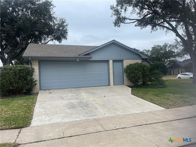 single story home with driveway, brick siding, a front yard, and a shingled roof