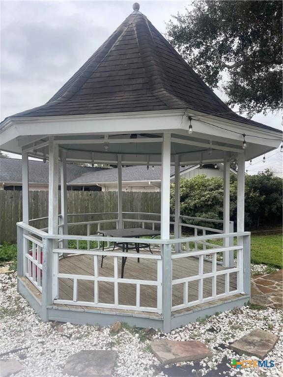 view of community featuring fence and a gazebo