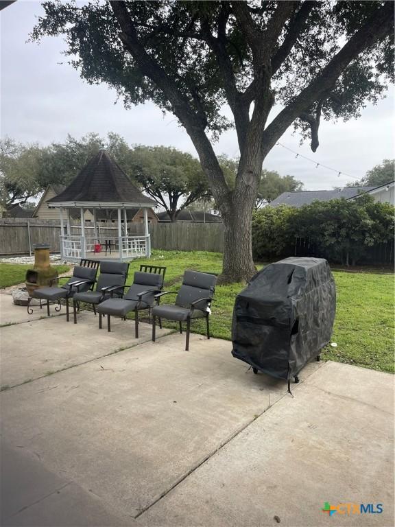 view of patio featuring a gazebo, area for grilling, and a fenced backyard