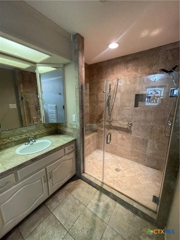 full bath featuring a stall shower, tile patterned flooring, and vanity