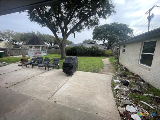 view of patio / terrace with a fenced backyard, grilling area, and a gazebo