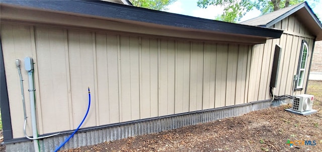 view of side of home featuring ac unit