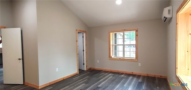 unfurnished bedroom with dark wood-type flooring, vaulted ceiling, and an AC wall unit