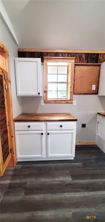 kitchen featuring dark wood-type flooring, white cabinets, and vaulted ceiling