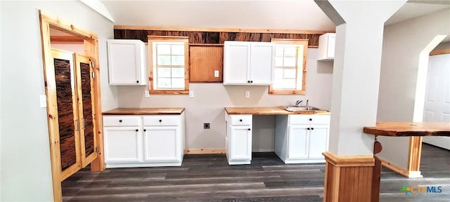 kitchen with white cabinetry, dark wood-type flooring, and sink