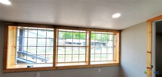 doorway with a textured ceiling