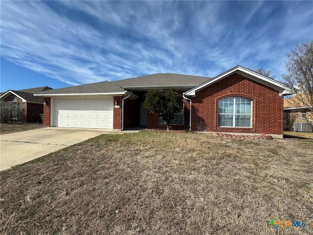 ranch-style house featuring a garage, central AC, and a front lawn