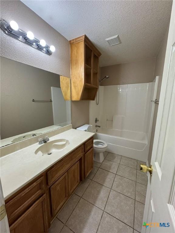 full bathroom with tile patterned flooring, vanity, a textured ceiling, bathtub / shower combination, and toilet