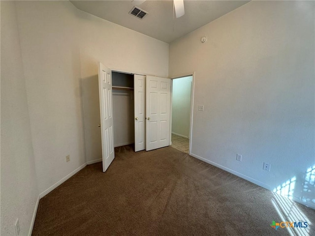 unfurnished bedroom with a closet, ceiling fan, and carpet flooring