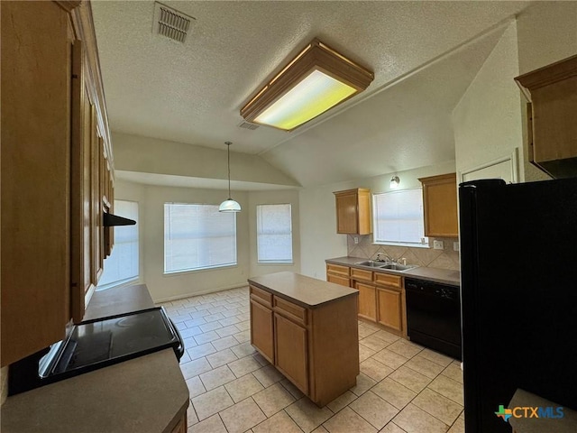 kitchen with vaulted ceiling, a kitchen island, sink, decorative backsplash, and black appliances